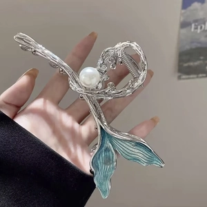 Fishtail hair claw clip in silver metal with ocean blue enamel and a central white pearl