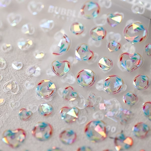 Laser rainbow heart and bubble nail stickers with iridescent foil effect on light base