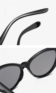 Detail of ergonomic curved temples and integrated nose pads on black cat-eye sunglasses