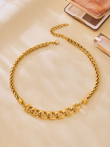 Detailed close-up of 18K gold-plated anchor chain necklace with lobster clasp