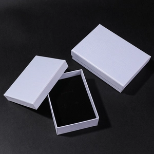 Macro view of light purple textured cardboard jewelry gift boxes with black foam inserts