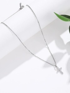 Macro detail of S925 sterling silver cross pendant necklace with white cubic zirconia