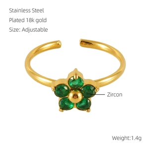 Detail of 18k gold plated stainless steel floral ring set with five green zircons