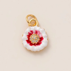 Macro view of flower pendant featuring 18K gold plating with red and white enamel petals