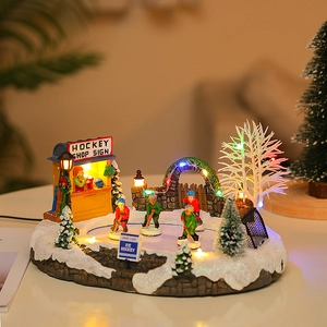 Macro detail of Christmas hockey scene featuring glowing LED lights and ice skater miniatures