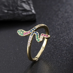 Macro view of gold snake ring with vibrant green pink and blue zircon stones detail