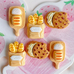 DIY resin accessories set with miniature cookies and yummy baguette bags on strawberry mat
