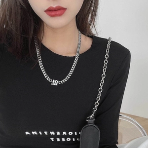 Polished silver titanium steel Cuban link chain necklace worn by a fashion model