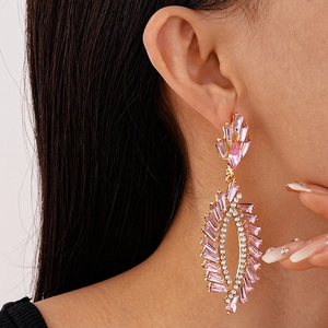 Close-up of pink crystal tassel earrings with sparkling rhinestones on female model