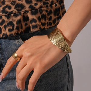 Detail of bohemian gold geometric multi-layer metal arm cuff and matching ring set