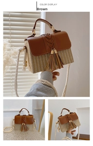 Straw saddle bag detail showing brown woven texture with tassels and cotton rope strap
