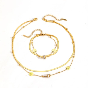 Gold double-layered necklace and bracelet set with four-leaf clover and crystal charms