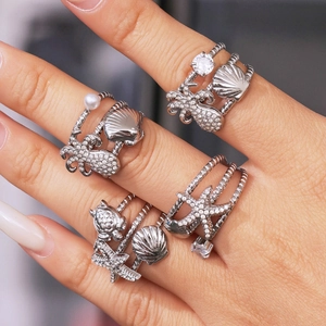 Silver marine ring set featuring octopus, starfish, turtle and shell with pearls