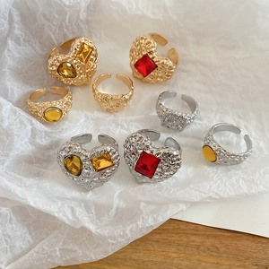 Detailed shot of vintage hammered metal rings with colorful resin heart-shaped gemstones