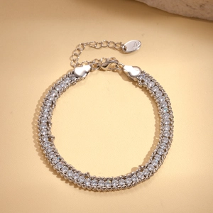 Detailed view of silver chain bracelet featuring double-row zircons and lobster clasp