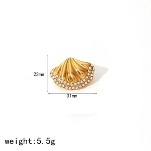 Detailed view of gold shell earrings with zircon inlays measuring 23mm by 31mm