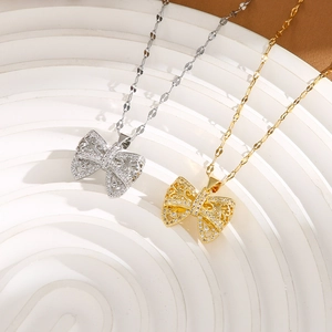 Detail showing bow pendant necklaces in gold and silver with delicate micro-pave crystals