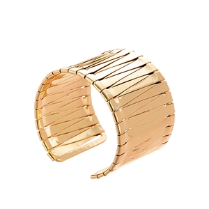 Modern wide gold cuff bracelet featuring bold textured stripe patterns on white background