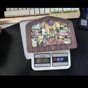 Weight measurement of wooden nativity puzzle showing 185.4g on a digital scale
