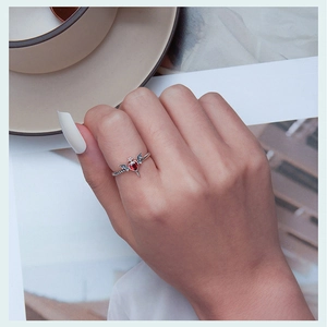 Gothic 925 sterling silver ring with red heart stone and bat wings on a hand