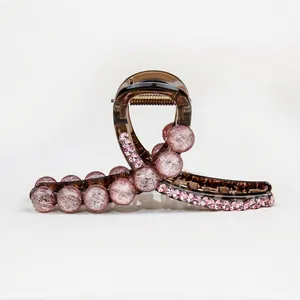 Brown acrylic hair claw clip with pink textured beads and sparkling rhinestones