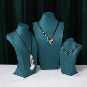 Three-piece dark green velvet necklace display stands in various sizes for jewelry staging