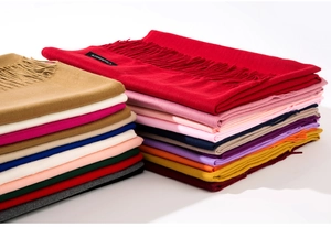 Close-up of multicolored cashmere scarves with elegant fringe details and soft texture