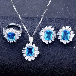 Macro detail of silver jewelry set with blue sapphire gemstones and diamond accents