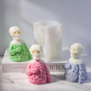 Macro detail of mummy skull silicone mold with textured gauze bandage wax candles