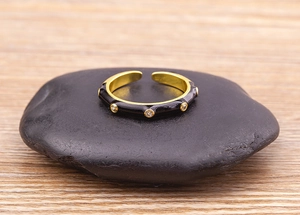 Detail of 18K gold plated open ring with black enamel and sparkling zircon stones