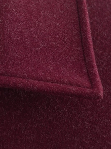 Detailed close-up showing the fine stitching and premium wool texture of the burgundy jacket