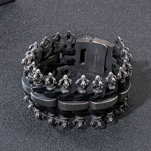 Close-up of gothic punk 316L stainless steel clasp and black braided leather texture