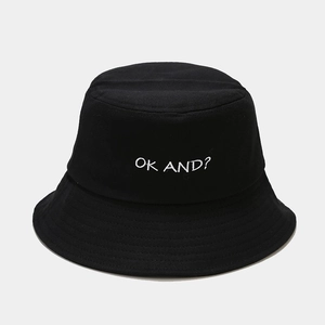 Detail of black cotton bucket hat featuring white 'OK AND?' embroidery and stitched brim