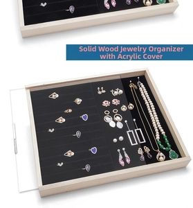 Solid wood jewelry tray with acrylic cover showing ring slots and necklace hooks