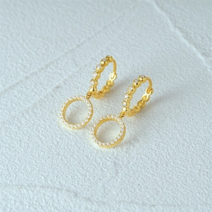 Detailed macro view of gold S925 silver hoop earrings with double pave zircon circles