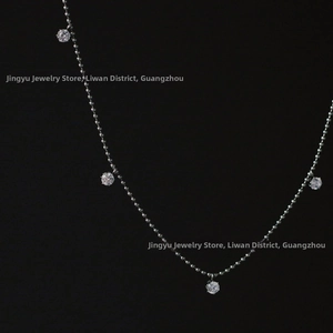 Detailed view of silver bead chain necklace featuring brilliant prong-set round crystals