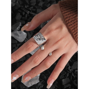 Irregular textured S925 sterling silver wide ring with liquid metal drop design on model hand