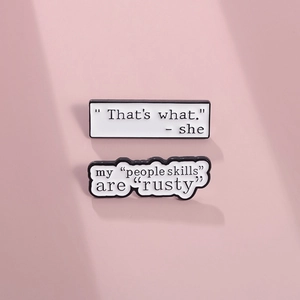 Creative geometric enamel pins with funny English quotes on a soft pink background