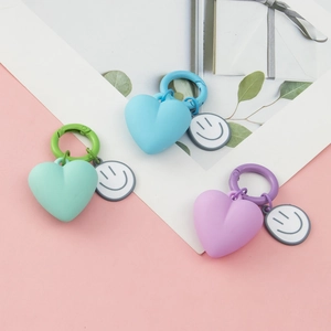 Colorful heart shaped keychains with smiley face charms and plastic lobster clasps
