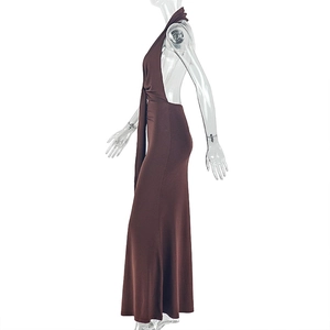 Detail of the backless halter dress in brown showing the waist pleats and fabric texture