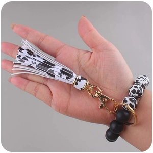 Silicone beaded wristlet keychain with cow print tassel and golden hardware accessory