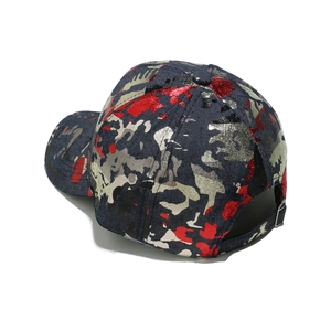 Detail of blue denim baseball cap with metallic camouflage print and adjustable metal buckle