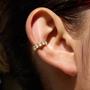 Minimalist 18K gold plated ear cuff featuring square cut zircon stones on a female model