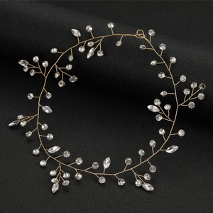 Detailed close-up of handmade bridal headband with gold wires and sparkling marquise crystals