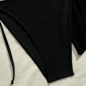 Detail of black bikini bottoms featuring high-elastic fabric and refined double-needle stitching