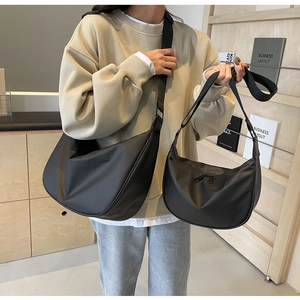 Comparison of two sizes of black crescent crossbody bags with adjustable straps