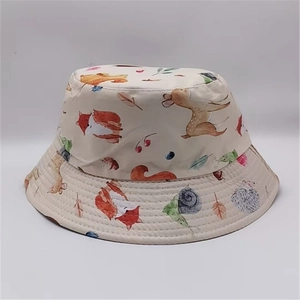 Detail of forest animal print on beige cotton bucket hat featuring fox and deer motifs