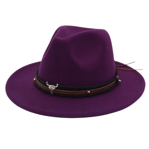 Detail of dark purple felt fedora hat featuring black braided belt with silver bull head charm