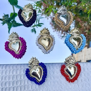 Handmade sacred heart earrings with colorful beads and golden metal flame charms