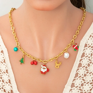 Golden Christmas charm necklace with Santa, reindeer and tree pendants worn by a model